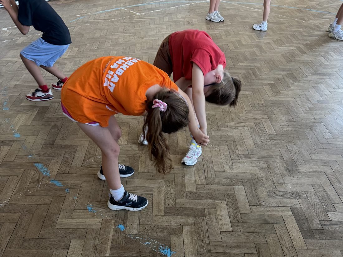 Young performers working through choreography in a hall