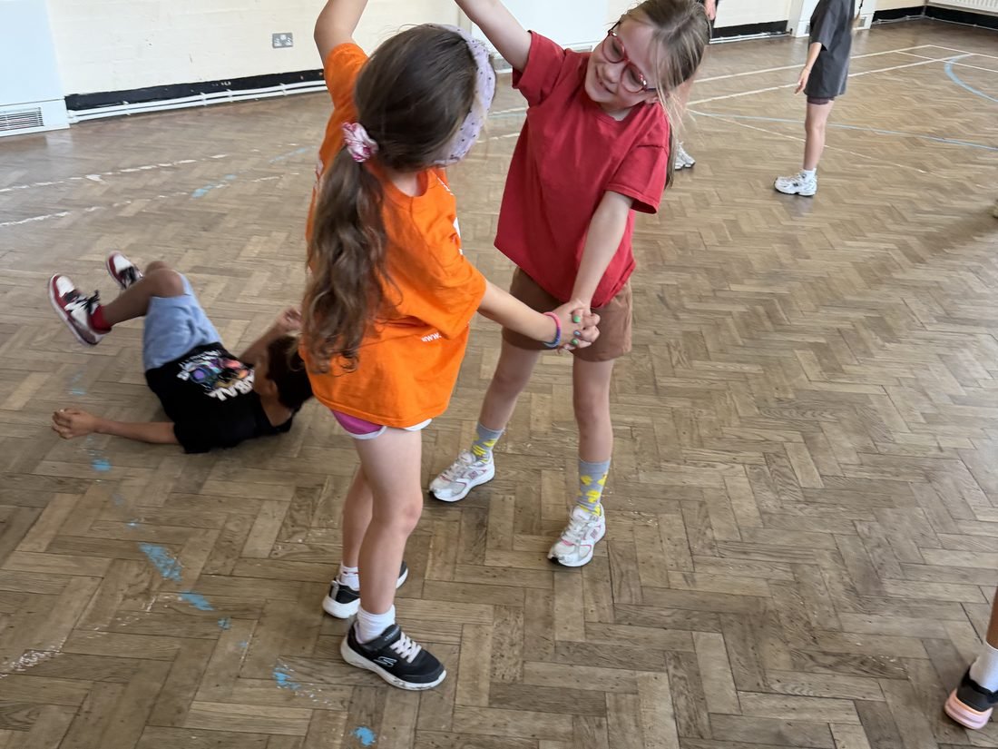 Young performers rehearsing a scene in pairs