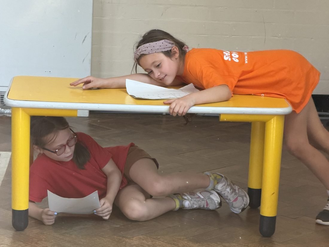 Two young performers in the middle of a comic scene during a session
