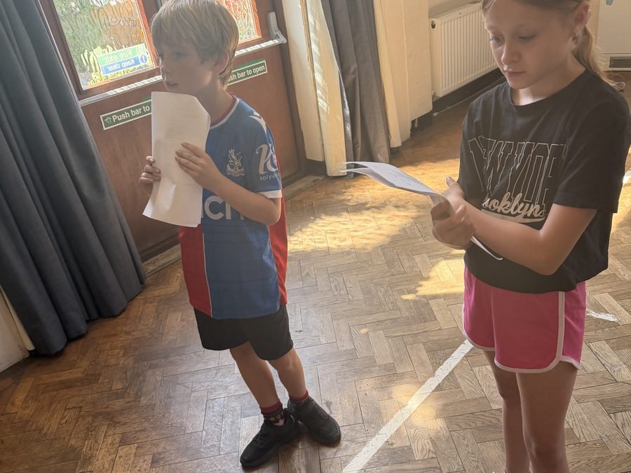 Two young performers working through a script together