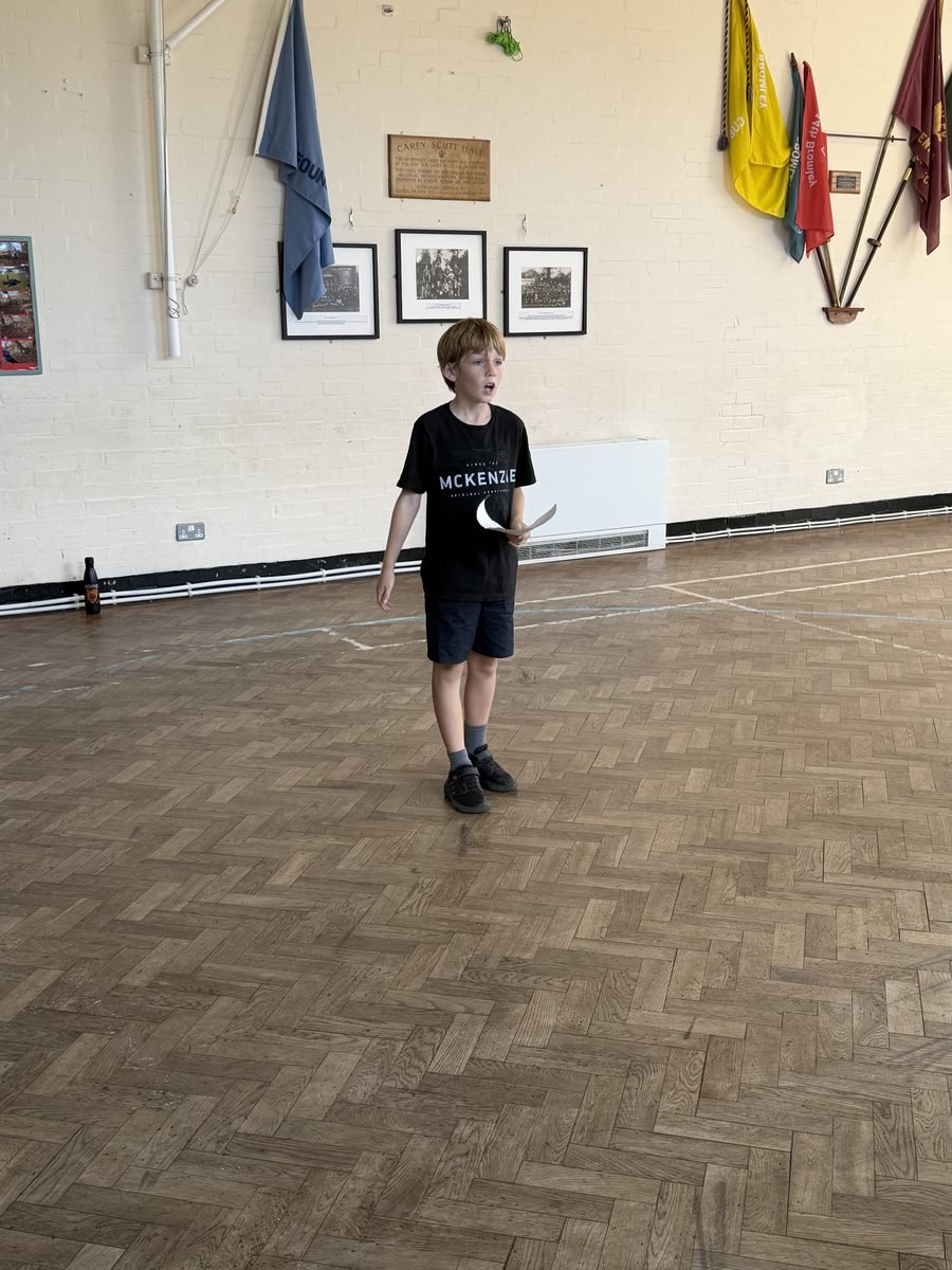 A young performer presenting to the room during a session